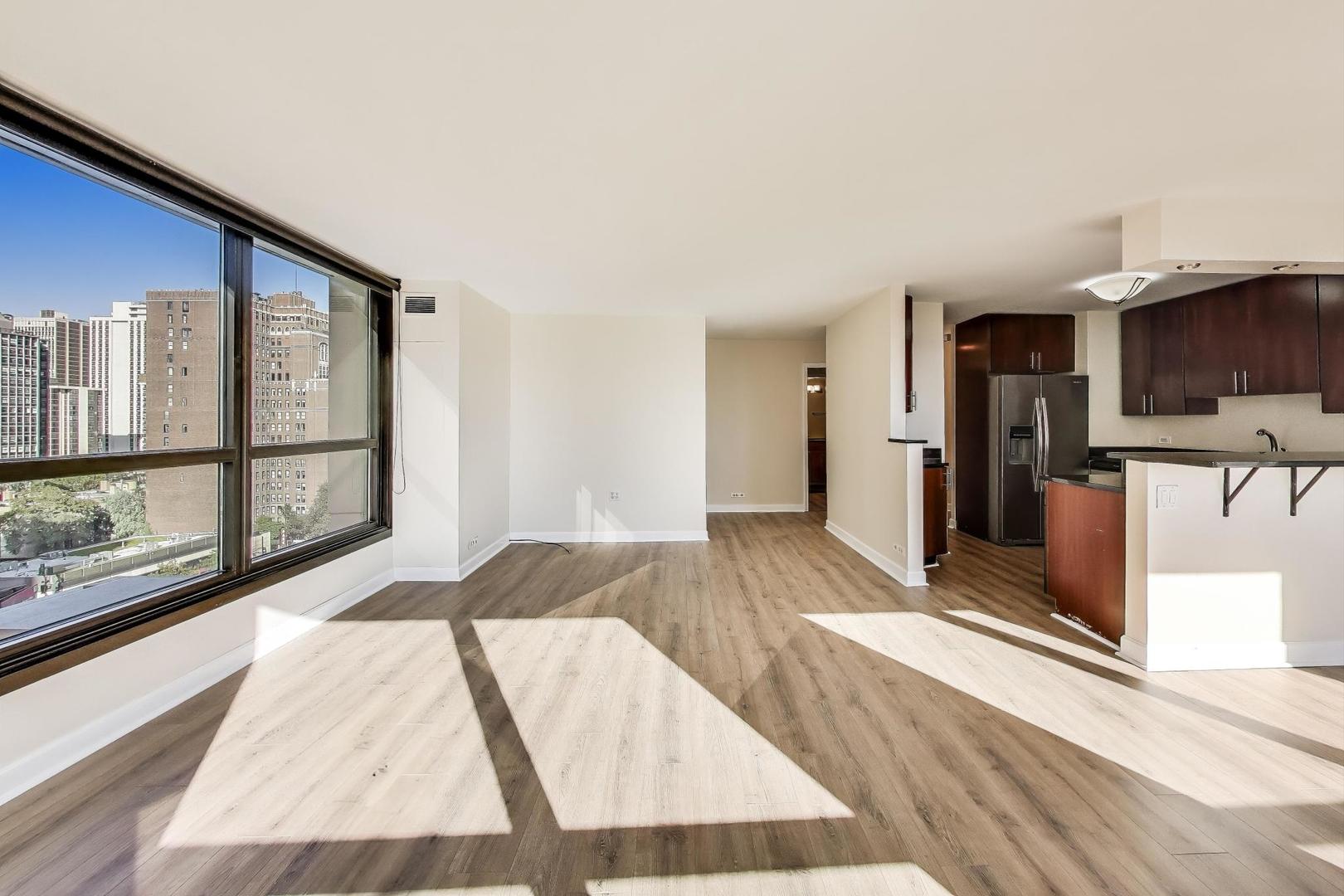 1030 North State Street, Unit 5B Chicago, IL 60610 - Photo 7 of 36 a view of a living room hardwood floor and a kitchen