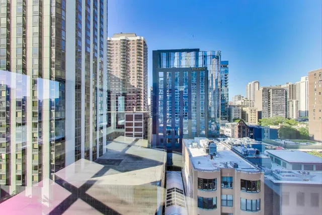 a workspace with furniture and a floor to ceiling window