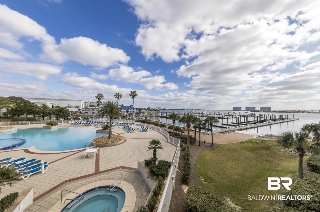 27800 Canal Road, Unit 212 Orange Beach, AL 36561 - Photo 3 of 43 Pool featuring a hot tub, a water view, and a patio