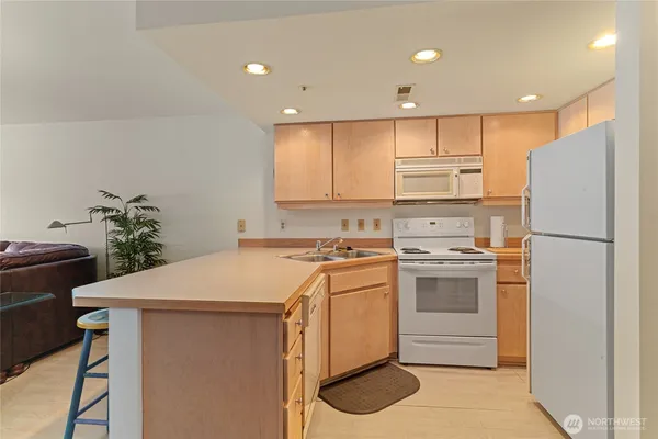 a kitchen with cabinets appliances and a counter space