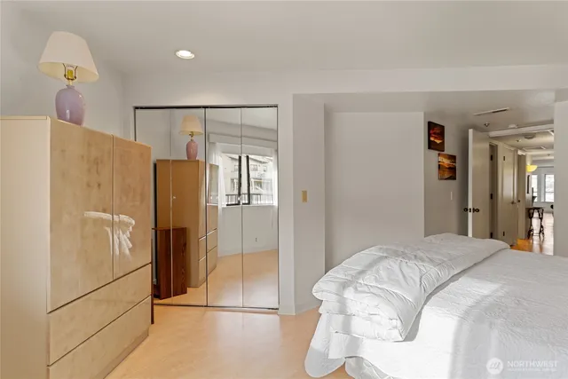 a bedroom with a bed and a refrigerator