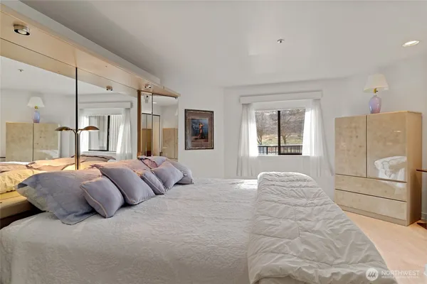 a bedroom with a bed and a refrigerator