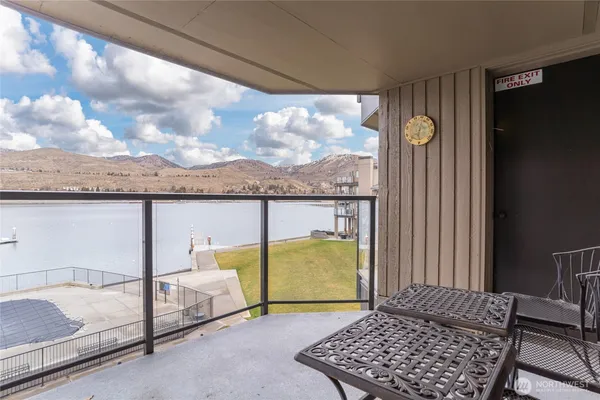 a view of a living room a dining room with furniture and wooden floor