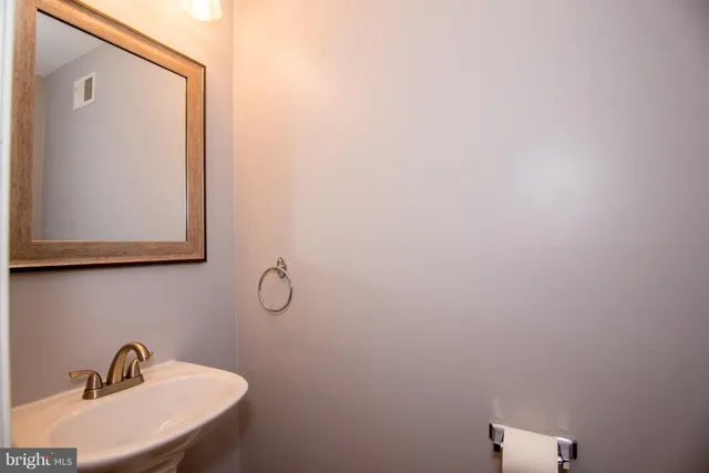 a bathroom with a sink and mirror