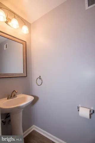 a bathroom with a sink a mirror and a toilet