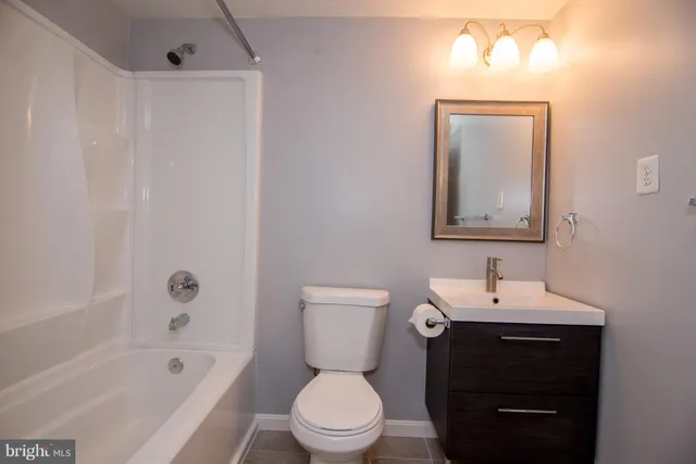 a view of backyard with small cabin and wooden fence