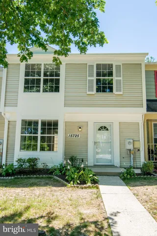 a view of a house with a backyard and trees