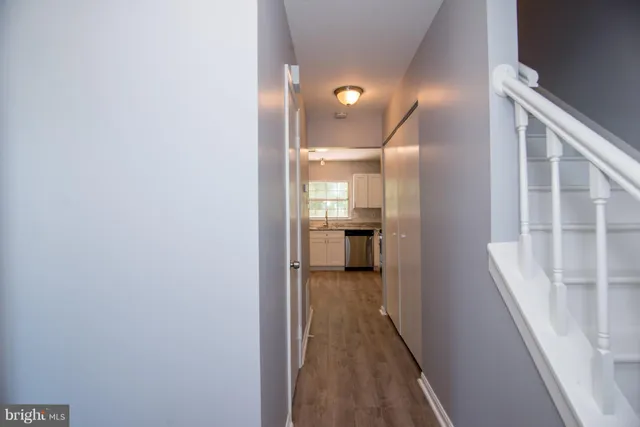 a view of a hallway with wooden floor