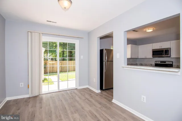 a view of a kitchen with a sink and a window