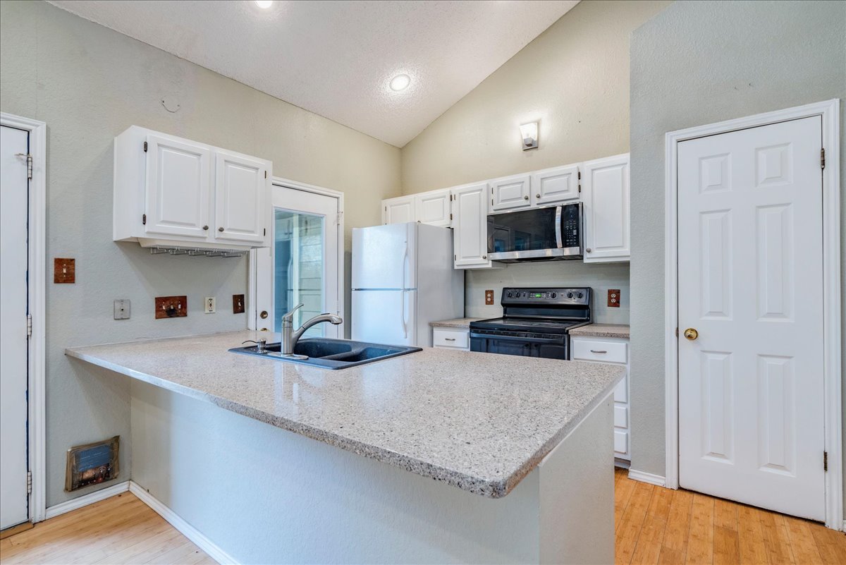 3809 Spicewood Springs Road, Unit 127 Austin, TX 78759 - Photo 8 of 29 A well-equipped kitchen features a functional layout with durable countertops and ample cabinetry.