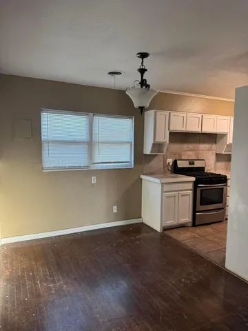 a kitchen with kitchen island a counter space a sink and appliances