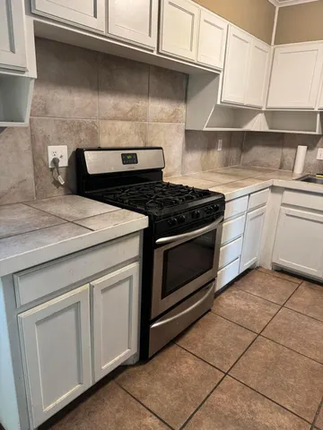 a kitchen with cabinets and appliances