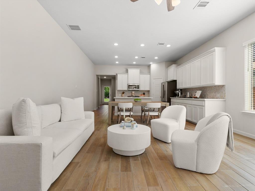 166 Palo Duro Bend Rhome, TX 76078 - Photo 6 of 40 Spacious living room with abundant natural light and open-concept layout.