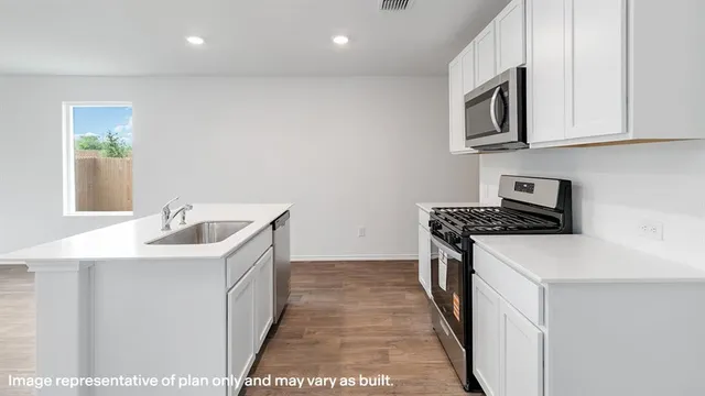 a kitchen with granite countertop white cabinets and black appliances