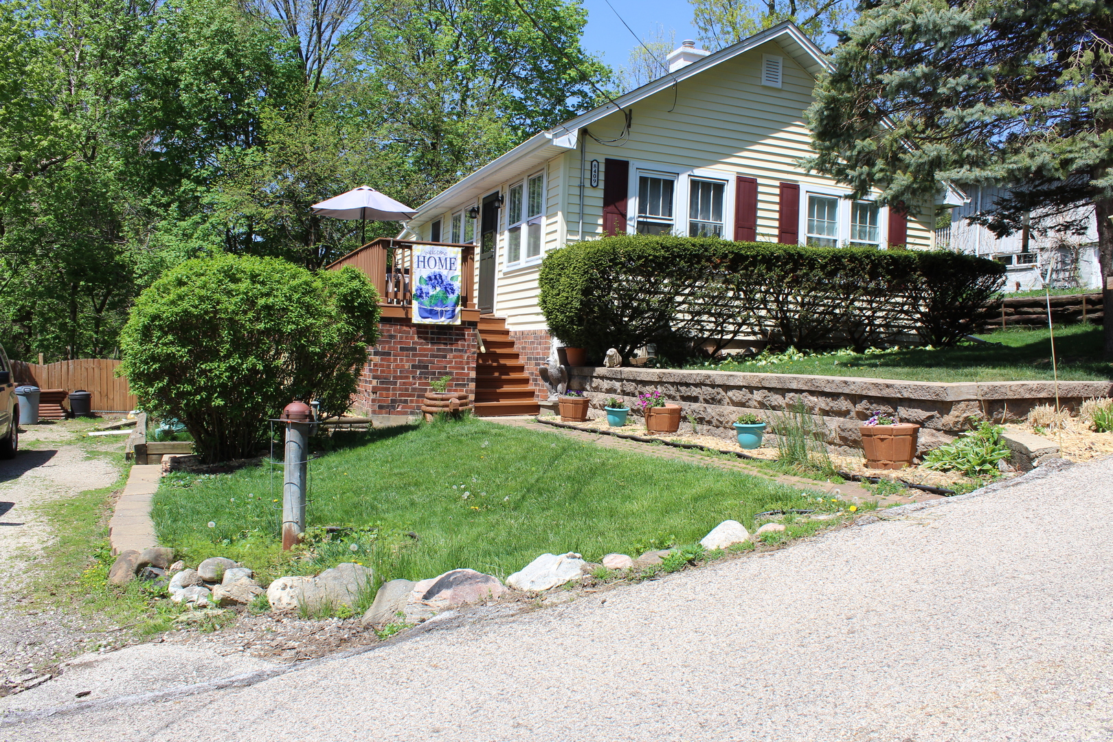 a front view of a house with a yard and green space