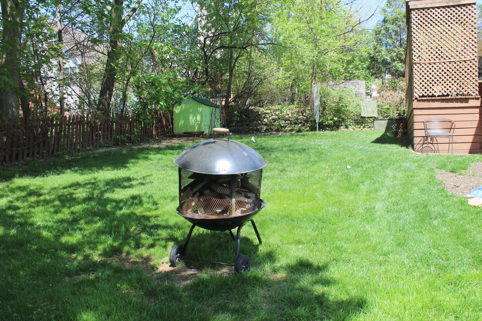 8409 Balder Drive Cary, IL 60013 - Photo 20 of 23 a view of a backyard with table and chairs and wooden fence