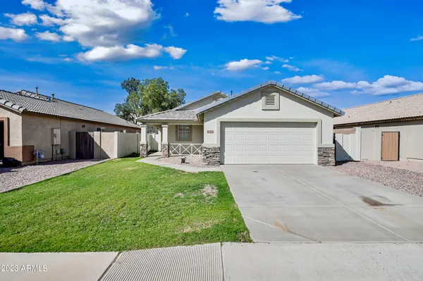a front view of a house with a yard and garage