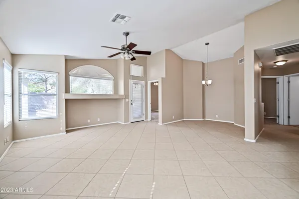 an empty room with a fireplace and windows