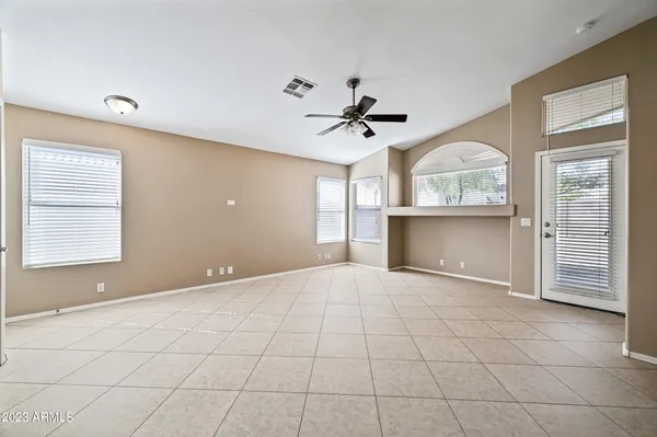 a view of empty room with cabinet and fireplace