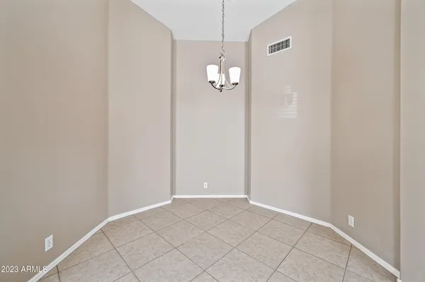a view of a chandelier fan and hardwood floor