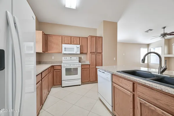 a kitchen with white cabinets and white appliances