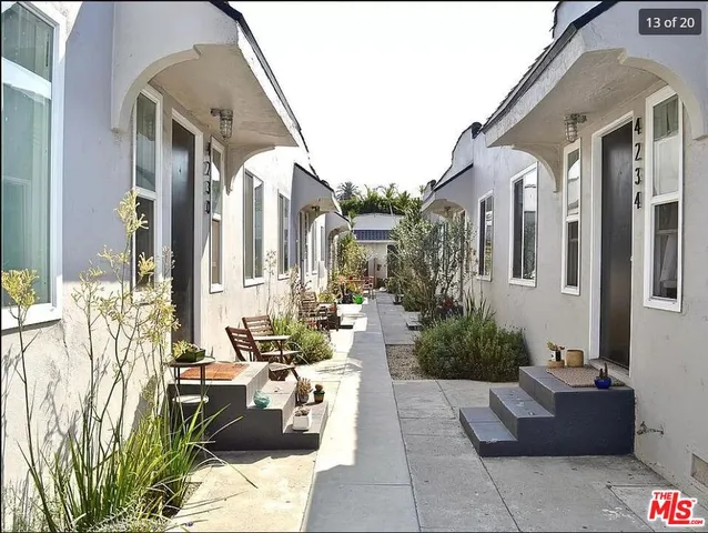 a view of a patio with couches and potted plants