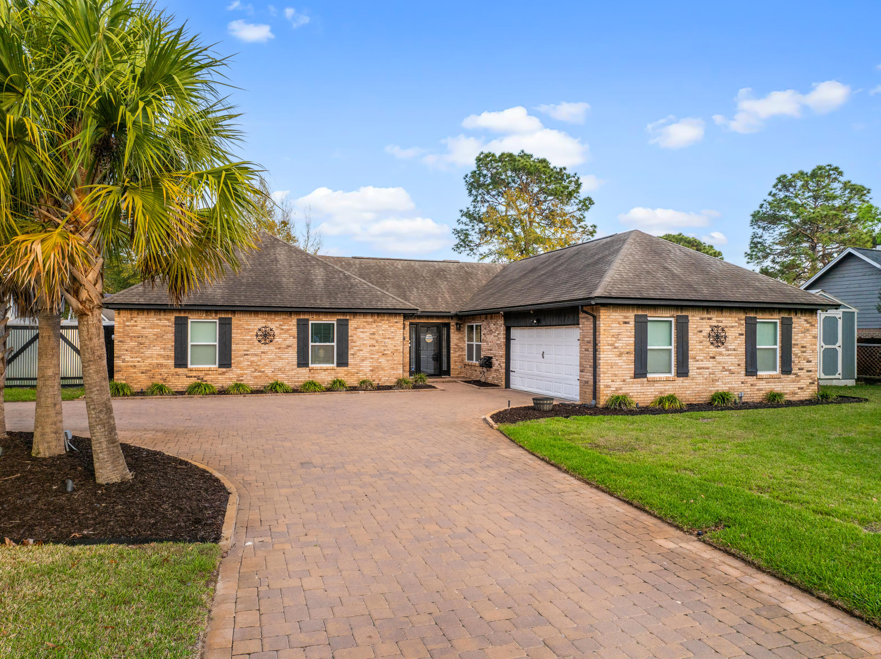 a front view of a house with a garden and yard