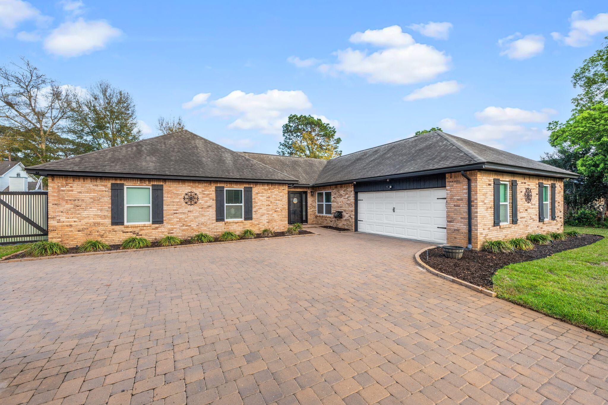 11 Hampton Circle Niceville, FL 32578 - Photo 48 of 79 a front view of a house with a yard and garage