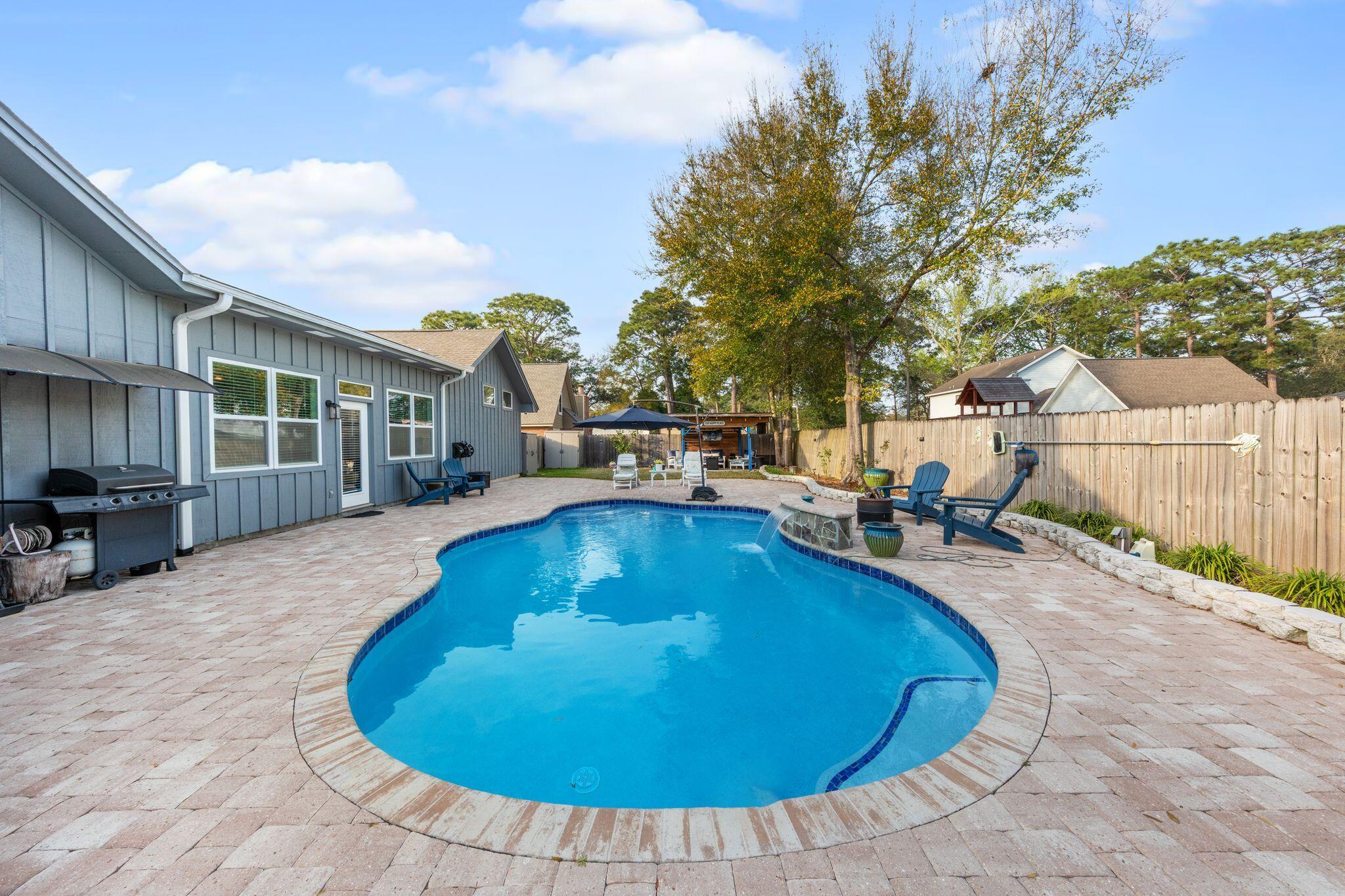 11 Hampton Circle Niceville, FL 32578 - Photo 63 of 79 a swimming pool with outdoor seating and yard