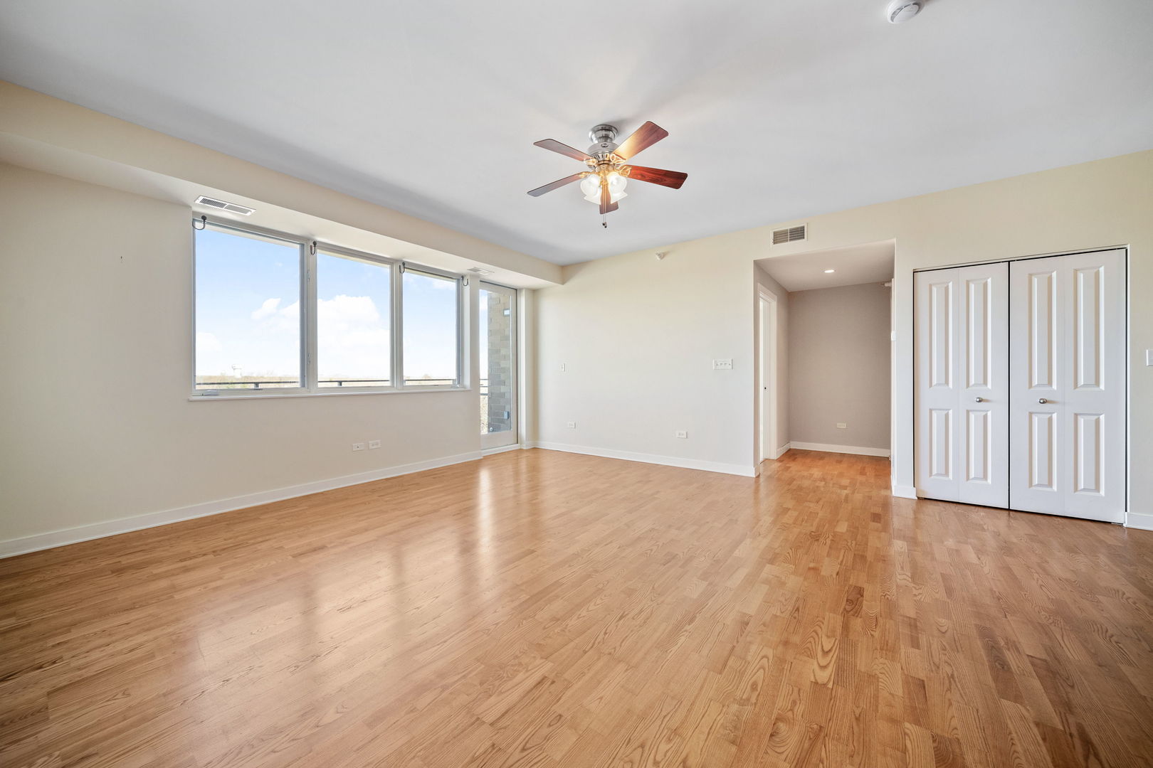 1905 South Wolf Road, Unit 605 Hillside, IL 60162 - Photo 13 of 31 an empty room with wooden floor and windows