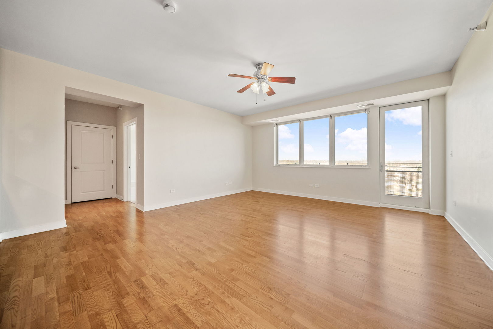 1905 South Wolf Road, Unit 605 Hillside, IL 60162 - Photo 3 of 31 a view of empty room with wooden floor and fan