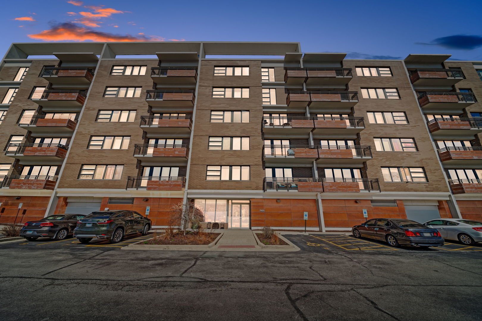1905 South Wolf Road, Unit 605 Hillside, IL 60162 - Photo 31 of 31 a front view of a building with lot of cars and trees
