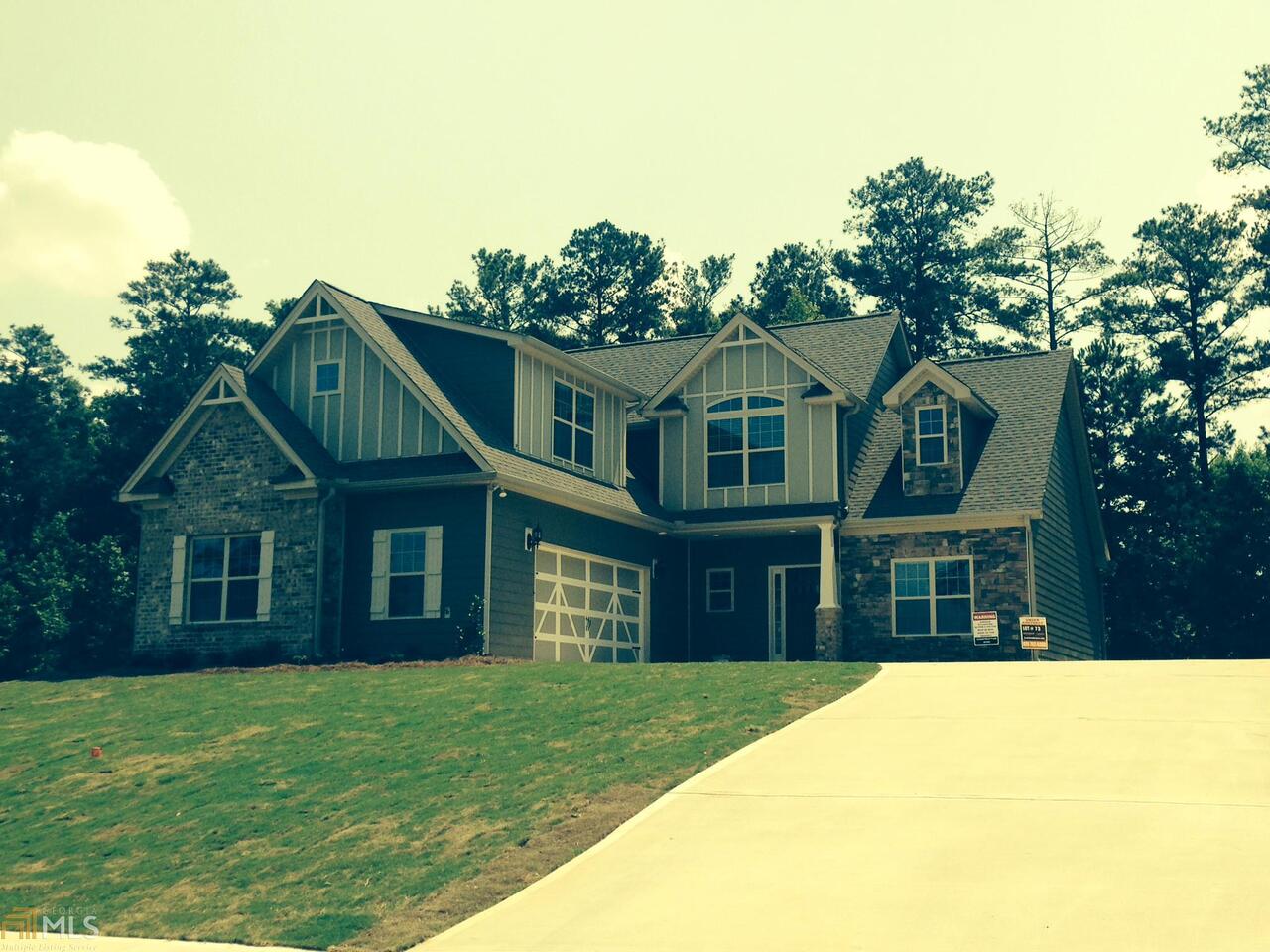 132 Caraway Road, Unit 73 Locust Grove, GA 30248 - Photo 1 of 1 a front view of a house with a garden