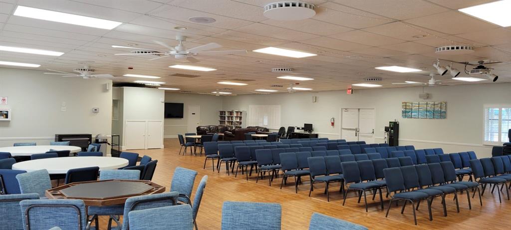 5245 Northwest 3rd Street, Unit D Delray Beach, FL 33445 - Photo 16 of 18 a living room with furniture a wooden floor and kitchen view
