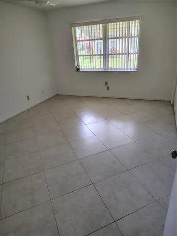 a bathroom with a granite countertop toilet and a sink