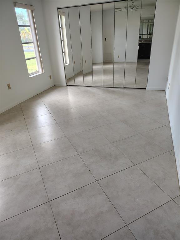 5245 Northwest 3rd Street, Unit D Delray Beach, FL 33445 - Photo 10 of 18 an empty room with windows