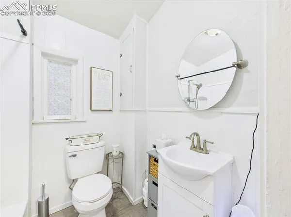 a white toilet sitting next to a bathroom sink