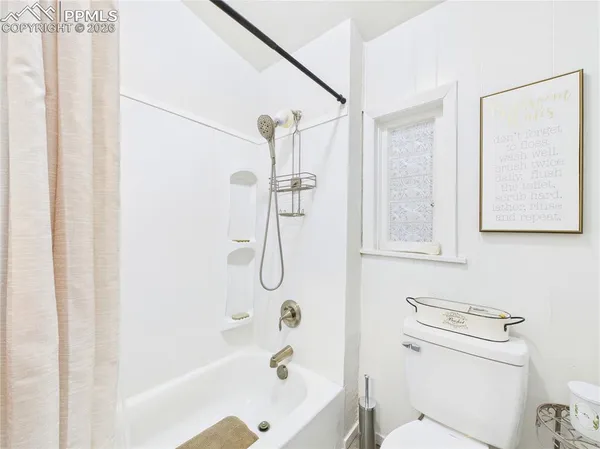 a bathroom with a shower a toilet and a shower