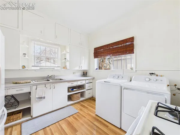 a kitchen with a sink stove and cabinets