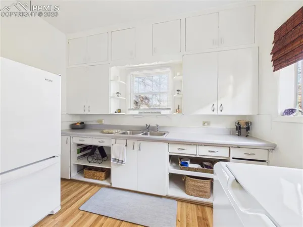 a kitchen with a stove a sink and a refrigerator