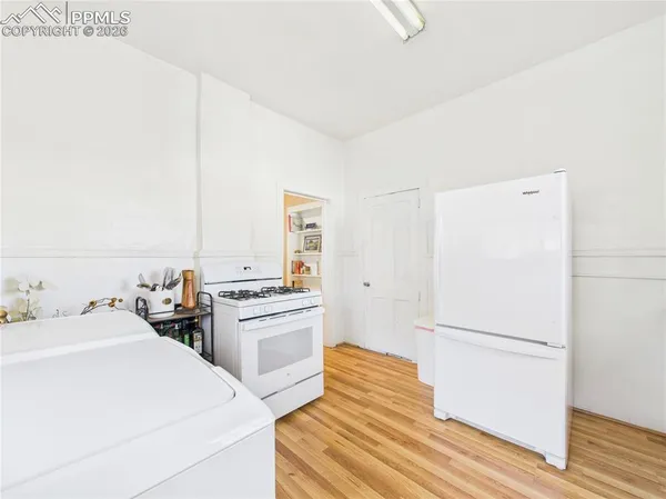 a kitchen with a refrigerator sink and white cabinets