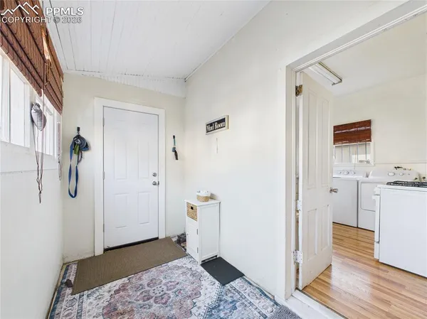 a view of a bathroom with closet and mirror