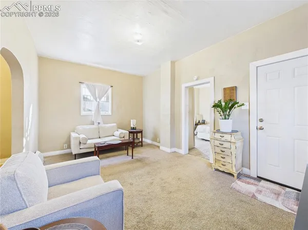 a living room with furniture and a table