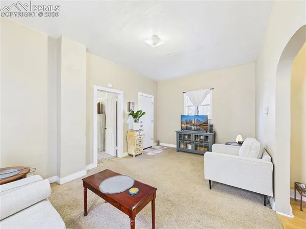a bedroom with furniture and a lamp