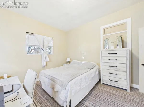 a bedroom with a bed and a dresser