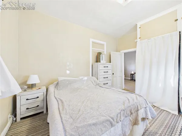 a bedroom with a bed and cabinets