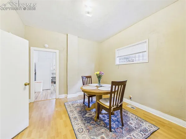 a view of a room with furniture and wooden floor
