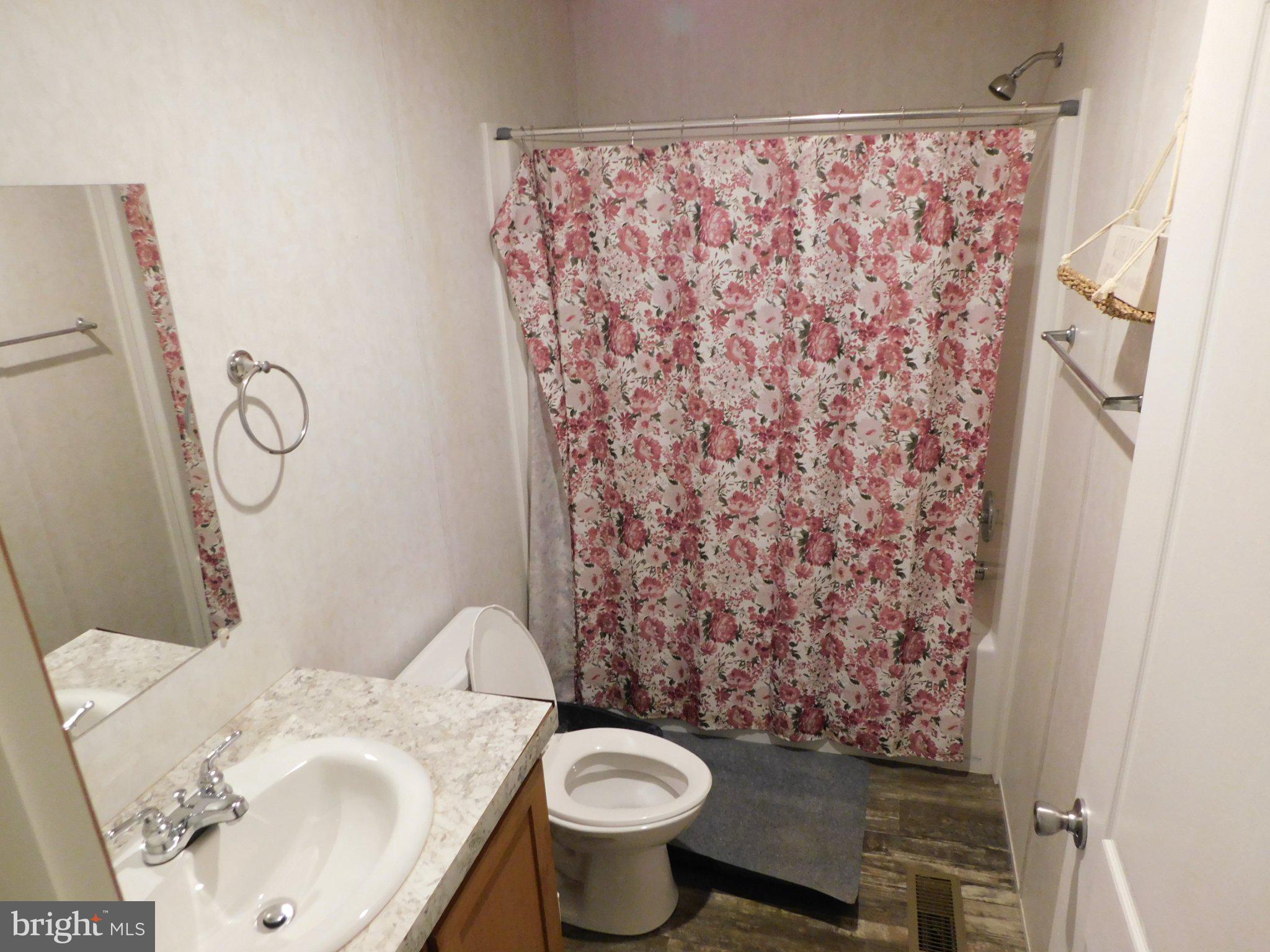 119 Meadow Lane Lititz, PA 17543 - Photo 10 of 13 a white toilet sitting next to a shower curtain