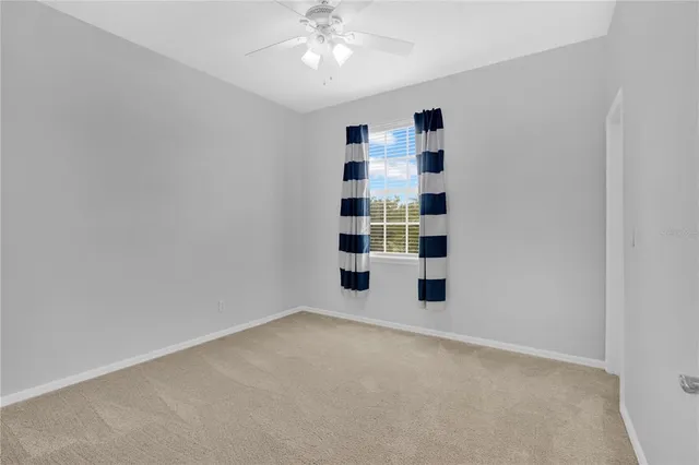 an empty room with windows and cabinet