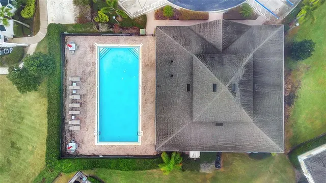 an aerial view of a house with pool patio and outdoor seating
